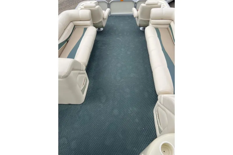 Slide: The Image of 2006 Bennington 2575 FS boat interior with beige seating and blue carpet. - 42