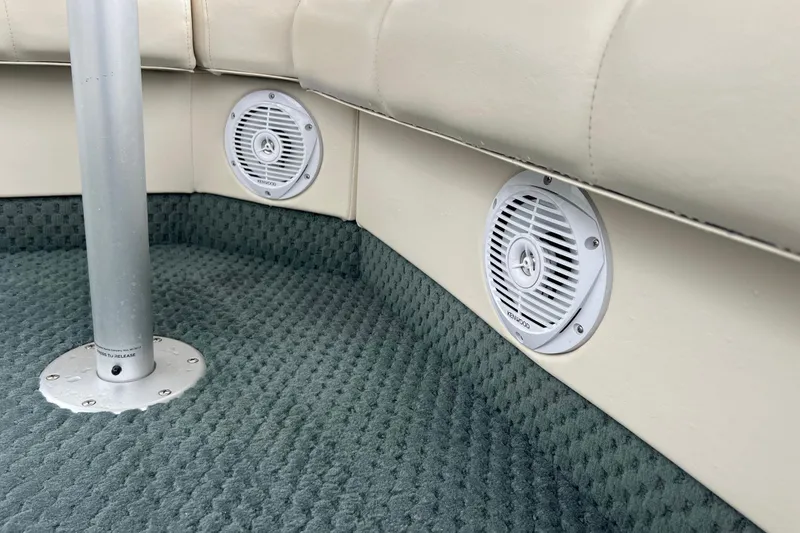 Slide: The Image of 2006 Bennington 2575 FS boat interior with Kenwood speakers and carpeted flooring. - 45