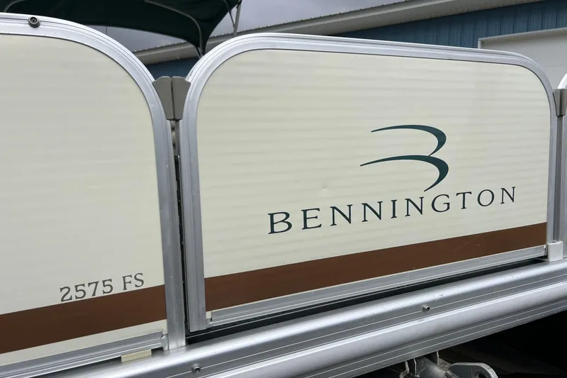 Slide: The Image of 2006 Bennington 2575 FS boat side view with logo and model details. - 5