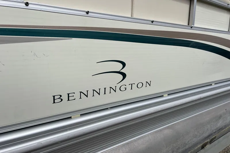 Slide: The Image of 2006 Bennington 2575 FS boat side view with logo and design details. - 9