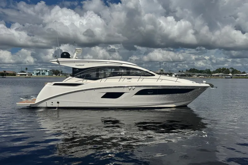 Slide: The Image of 2016 Sea Ray 400 Sundancer yacht on calm water under cloudy sky. - 0