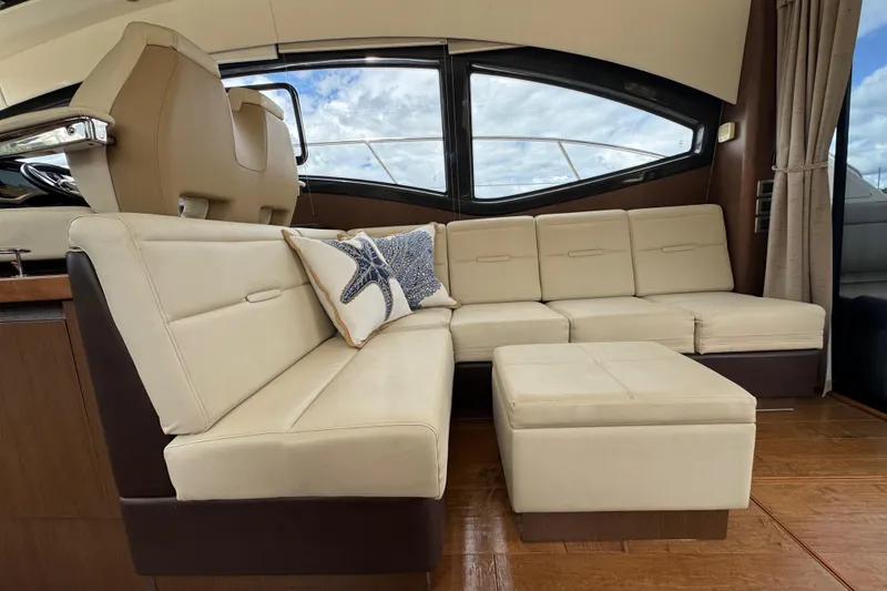 Slide: The Image of Luxurious interior of 2016 Sea Ray 400 Sundancer with cream leather seating and starfish pillow. - 14
