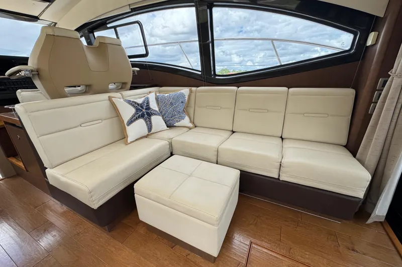 Slide: The Image of Luxurious interior of 2016 Sea Ray 400 Sundancer with cream leather seating and starfish pillow. - 15