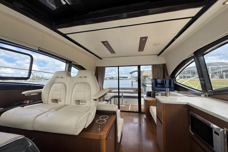 Slide: The Image of Luxurious interior of 2016 Sea Ray 400 Sundancer yacht with plush seating and modern amenities. - 16