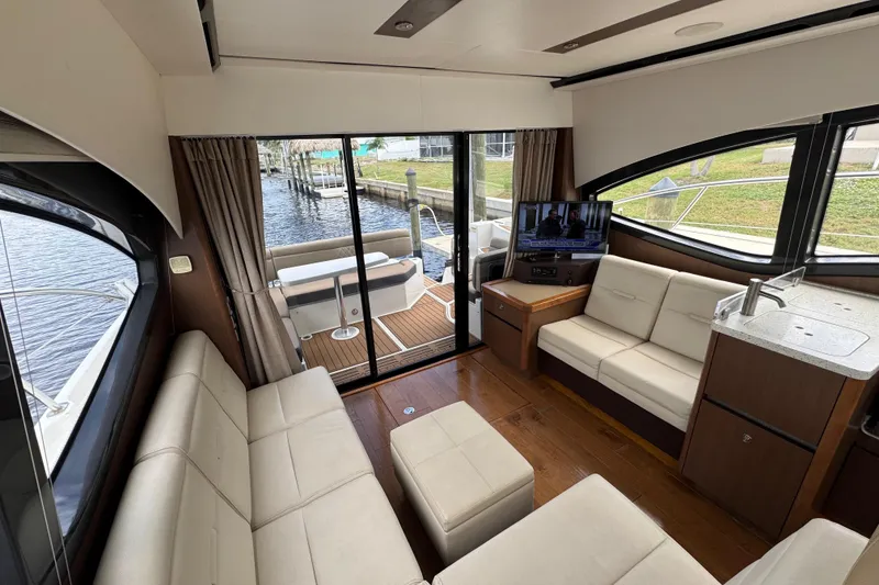 Slide: The Image of Luxurious interior of 2016 Sea Ray 400 Sundancer yacht with modern seating and entertainment area. - 17