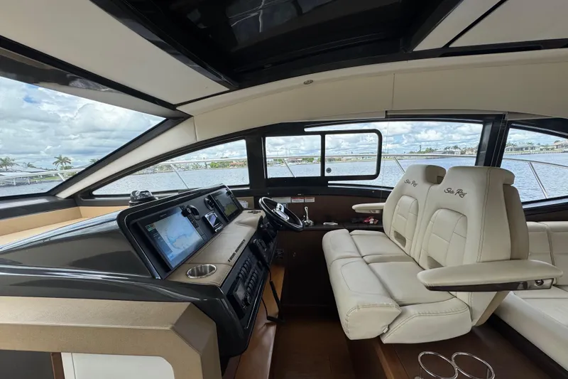 Slide: The Image of Interior view of 2016 Sea Ray 400 Sundancer yacht cockpit with modern navigation system. - 21