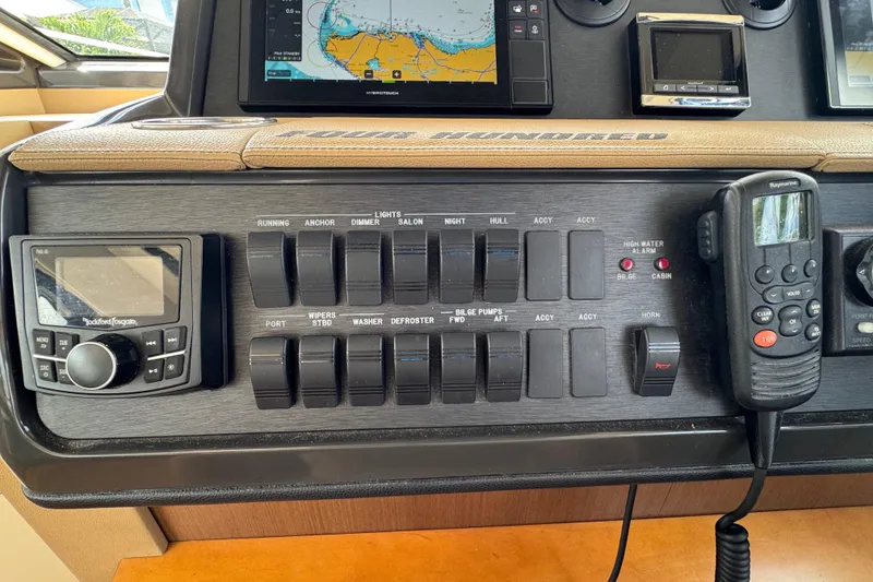 Slide: The Image of Control panel of a 2016 Sea Ray 400 Sundancer boat with navigation and communication devices. - 27