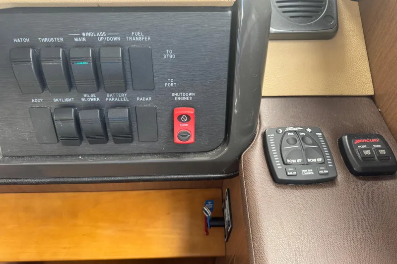 Slide: The Image of Control panel of a 2016 Sea Ray 400 Sundancer boat with various switches and buttons. - 28
