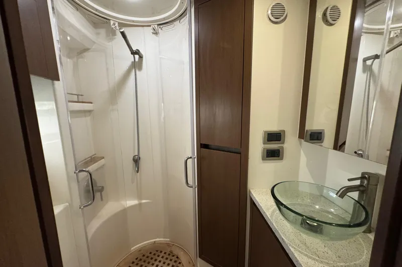 Slide: The Image of Luxurious bathroom in 2016 Sea Ray 400 Sundancer yacht with glass sink and shower. - 32