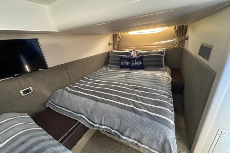Slide: The Image of Luxurious bedroom interior of 2016 Sea Ray 400 Sundancer yacht with striped bedding. - 36