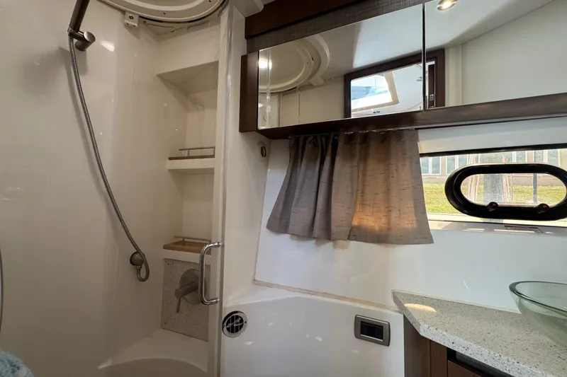 Slide: The Image of Luxurious bathroom interior of 2016 Sea Ray 400 Sundancer yacht with shower and window. - 40