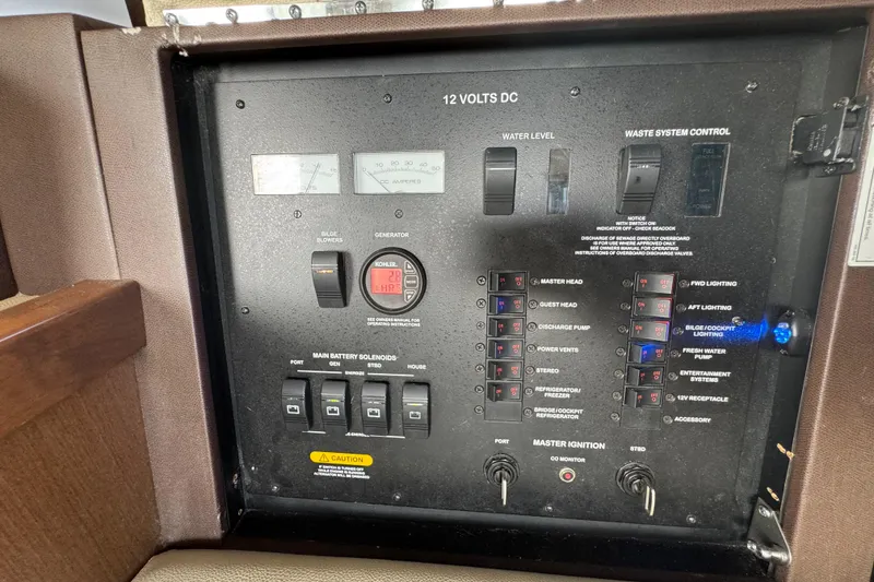 Slide: The Image of Control panel of a 2016 Sea Ray 400 Sundancer boat, featuring various switches and gauges. - 42