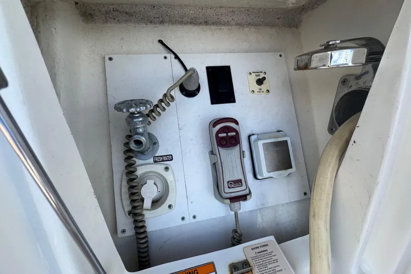 Slide: The Image of Control panel of a 2016 Sea Ray 400 Sundancer boat with various switches and connections. - 43