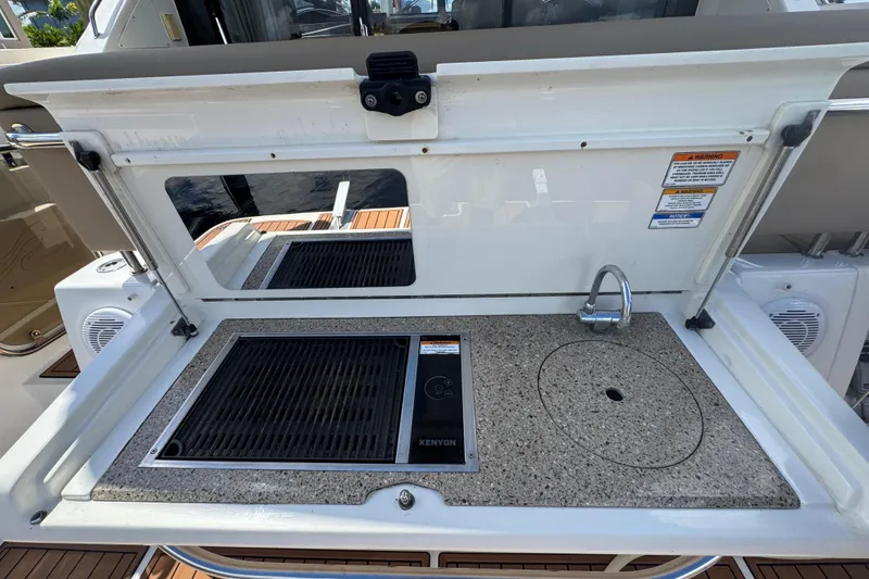 Slide: The Image of Outdoor kitchenette on 2016 Sea Ray 400 Sundancer yacht with grill and sink. - 6