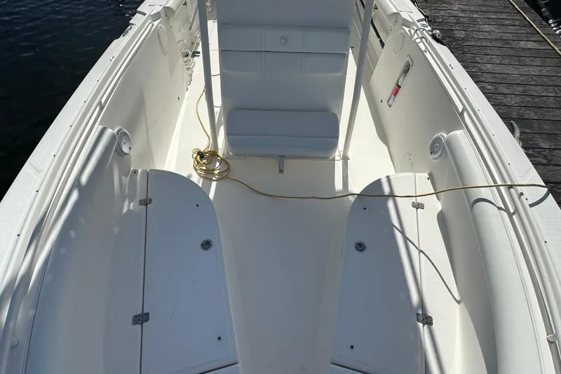 Slide: The Image of 2004 Edgewater 245CC boat interior with seating and storage compartments. - 13