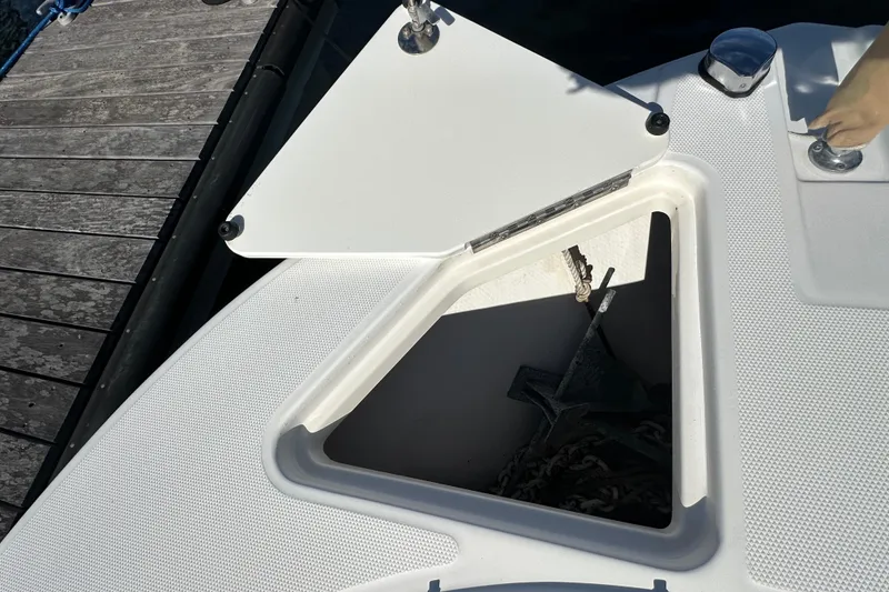 Slide: The Image of Open anchor compartment on 2004 Edgewater 245CC boat, dockside view. - 14
