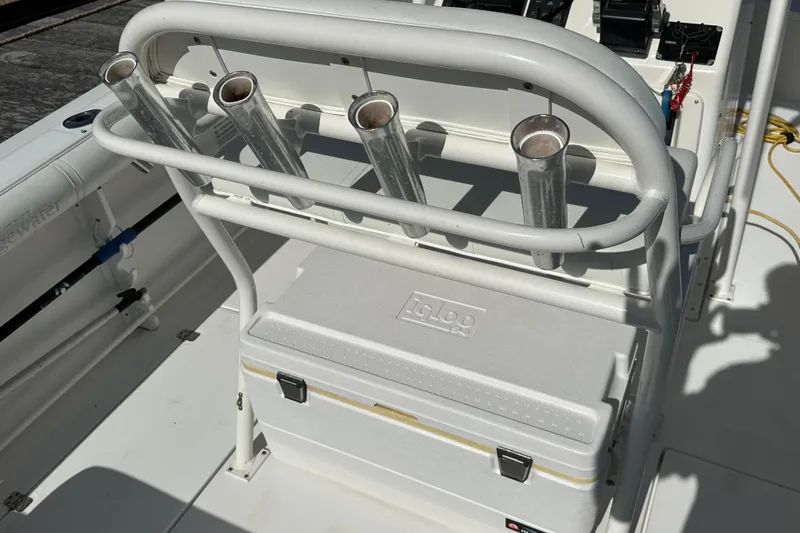 Slide: The Image of 2004 Edgewater 245CC boat interior with rod holders and Igloo cooler. - 19
