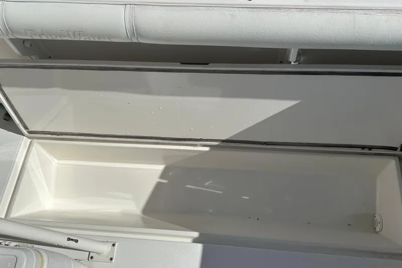 Slide: The Image of Open storage compartment on 2004 Edgewater 245CC boat, showcasing interior space. - 20