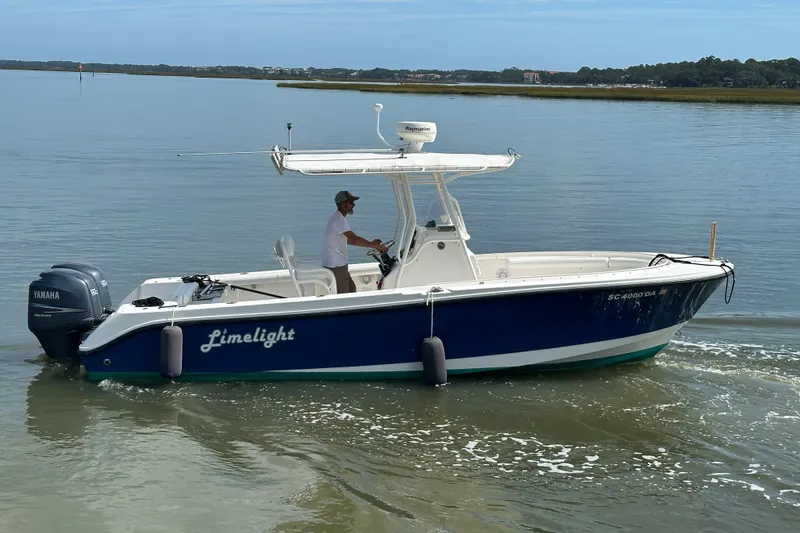 Slide: The Image of 2004 Edgewater 245CC boat named "Limelight" cruising on calm waters. - 4