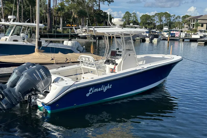 Slide: The Image of 2004 Edgewater 245CC boat named Limelight docked in a marina with Yamaha engines. - 7