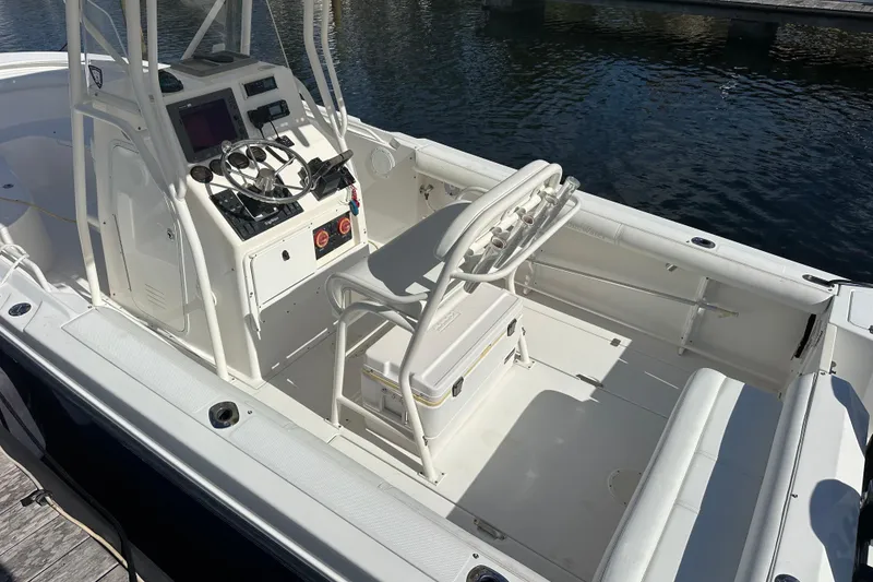Slide: The Image of 2004 Edgewater 245CC boat interior with helm, seating, and water view. - 9