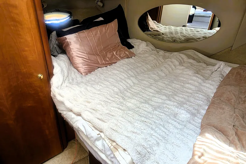 Slide: The Image of Cozy bedroom in 1998 Silverton 352 Motor Yacht with plush bedding and oval mirror. - 10