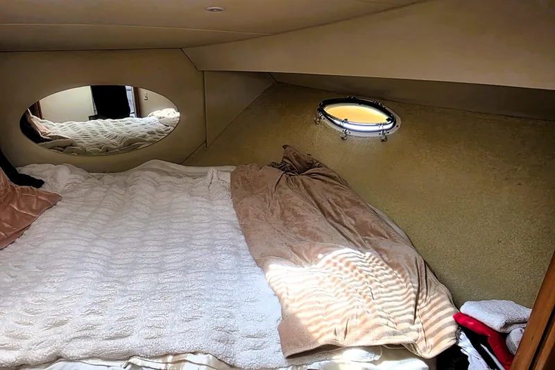 Slide: The Image of Cozy cabin interior of 1998 Silverton 352 Motor Yacht with bed and porthole window. - 11