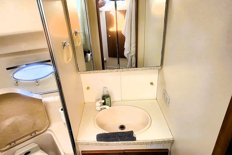 Slide: The Image of Bathroom vanity in 1998 Silverton 352 Motor Yacht with sink and mirror. - 12