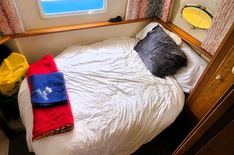 Slide: The Image of Cozy bedroom in 1998 Silverton 352 Motor Yacht with window and colorful towels. - 14