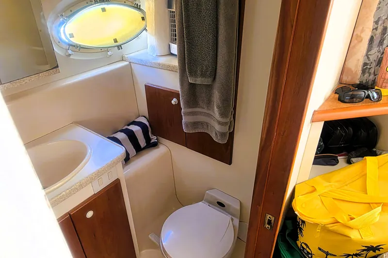 Slide: The Image of Bathroom interior of 1998 Silverton 352 Motor Yacht with sink, toilet, and storage. - 17