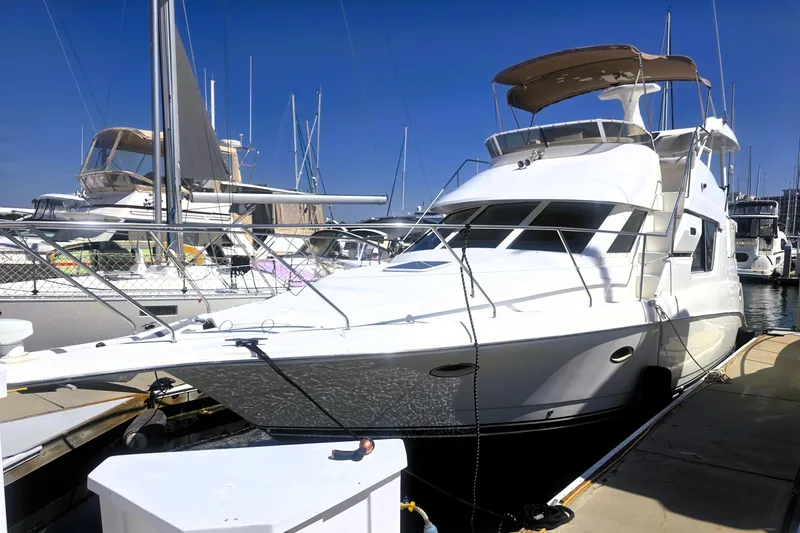 Slide: The Image of 1998 Silverton 352 Motor Yacht docked at marina under clear blue sky. - 19