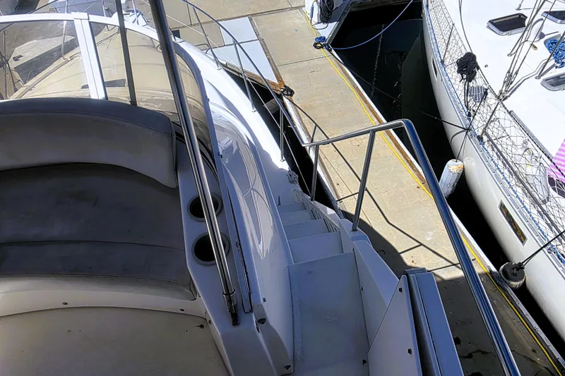 Slide: The Image of 1998 Silverton 352 Motor Yacht docked, showing deck and seating area. - 23