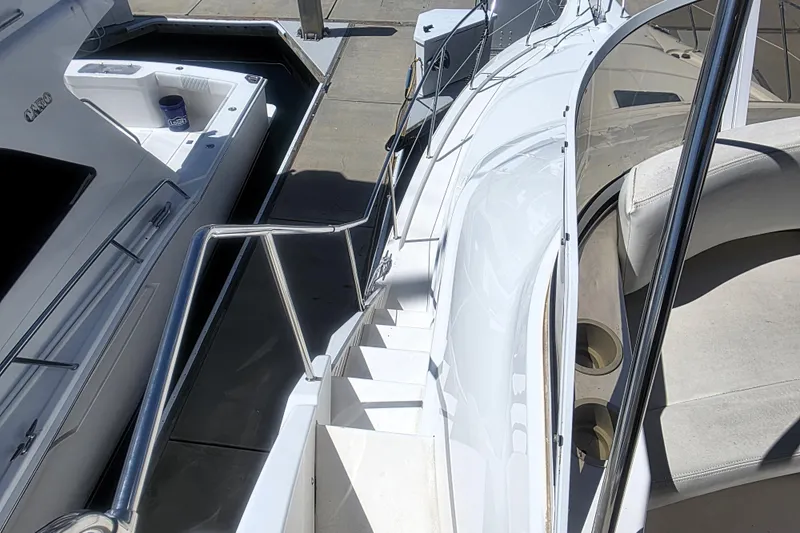 Slide: The Image of 1998 Silverton 352 Motor Yacht docked, showing deck and seating area. - 24