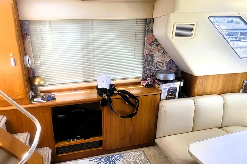 Slide: The Image of Interior of 1998 Silverton 352 Motor Yacht with cozy seating and modern decor. - 7