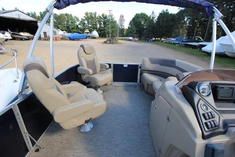 Slide: The Image of 2022 Sylvan L3 LZ pontoon boat interior with seating and control panel. - 11