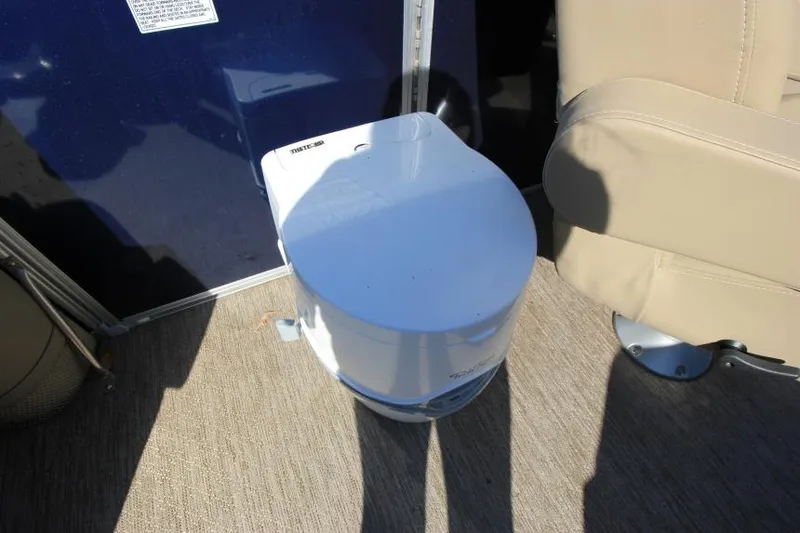 Slide: The Image of Portable toilet on 2022 Sylvan L3 LZ boat deck, next to beige seat. - 15
