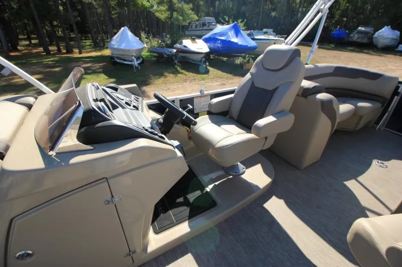 Slide: The Image of 2022 Sylvan L3 LZ boat interior with captain's chair and control panel. - 8