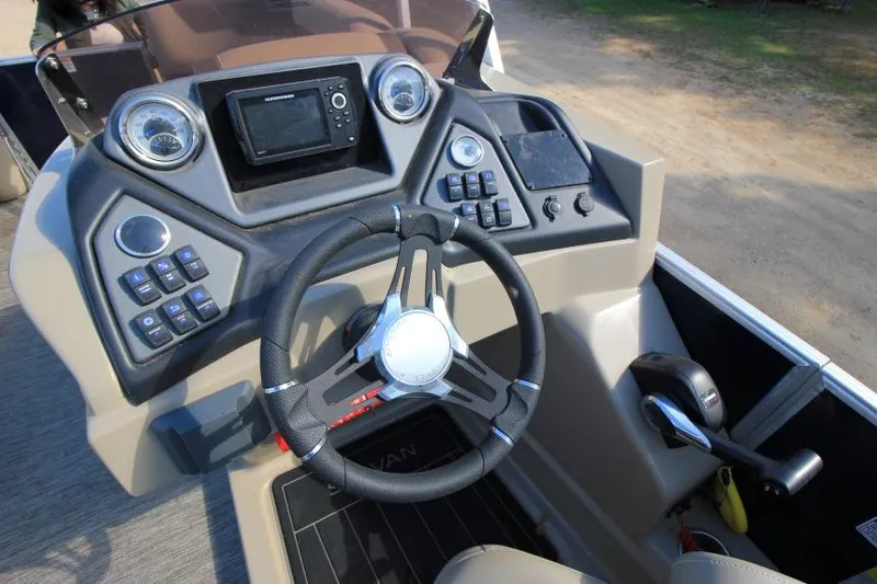 Slide: The Image of 2022 Sylvan L3 LZ boat dashboard with steering wheel and control panel. - 9