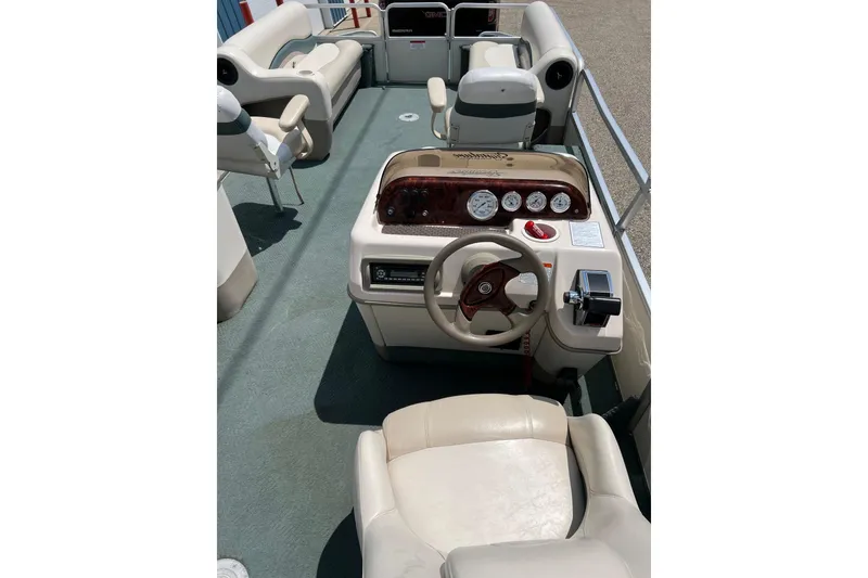 Slide: The Image of 2006 Sun Tracker Party Barge 24 interior with steering console and seating. - 11