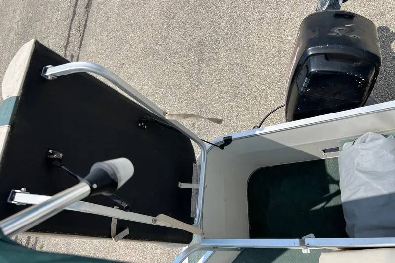 Slide: The Image of 2006 Sun Tracker Party Barge 24 with motor and open storage compartment. - 13