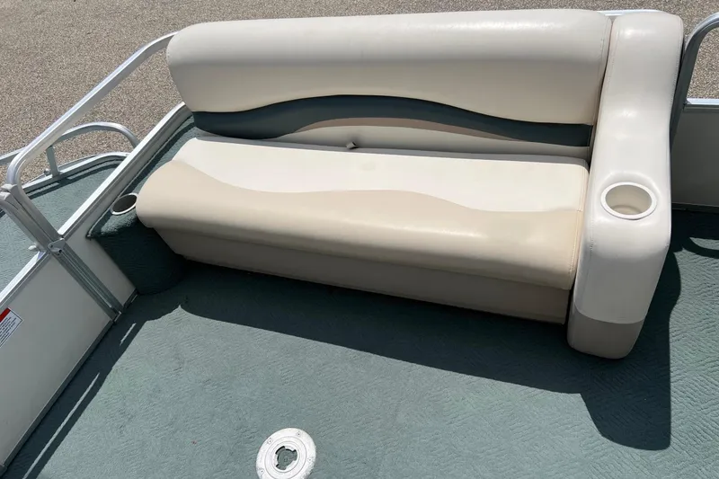 Slide: The Image of 2006 Sun Tracker Party Barge 24 pontoon boat seating with cup holder, beige upholstery. - 16
