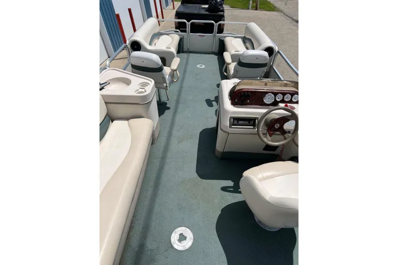 Slide: The Image of 2006 Sun Tracker Party Barge 24 interior with seating and steering console. - 24