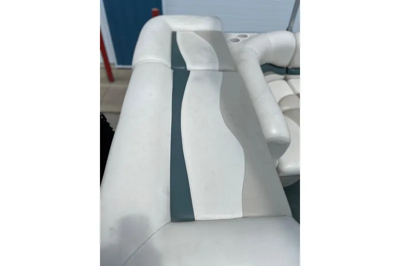 Slide: The Image of 2006 Sun Tracker Party Barge 24 interior seating with white and gray upholstery. - 27