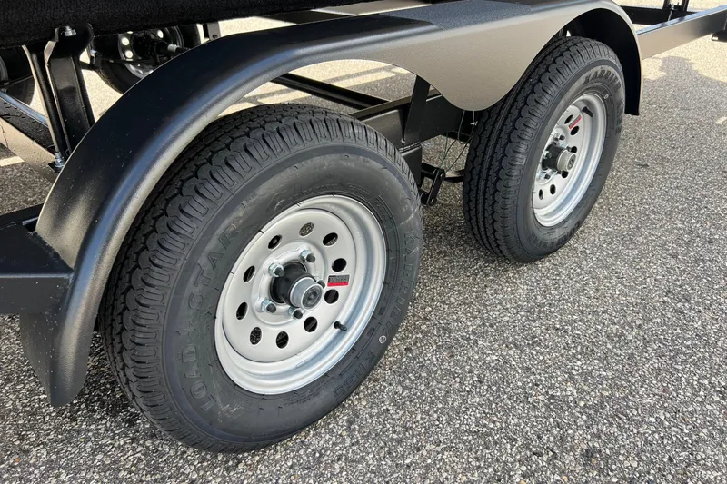 Slide: The Image of Trailer wheels of a 2006 Sun Tracker Party Barge 24 on asphalt. - 3