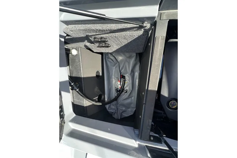 Slide: The Image of 2023 Malibu Wakesetter 22 LSV storage compartment with hydraulic lift and wiring. - 14