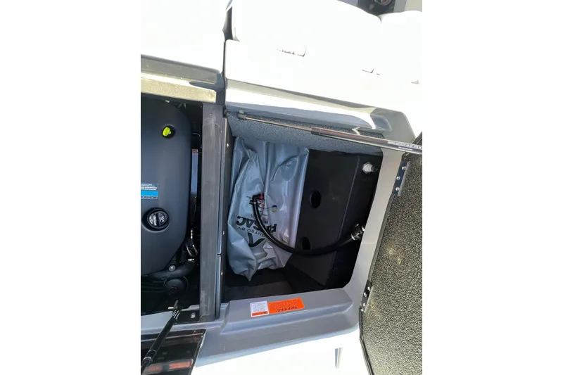 Slide: The Image of 2023 Malibu Wakesetter 22 LSV storage compartment with ballast bag and engine components. - 15