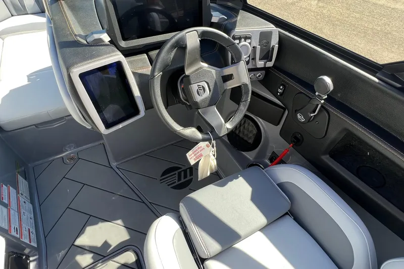 Slide: The Image of 2023 Malibu Wakesetter 22 LSV boat interior with modern steering and control panel. - 18