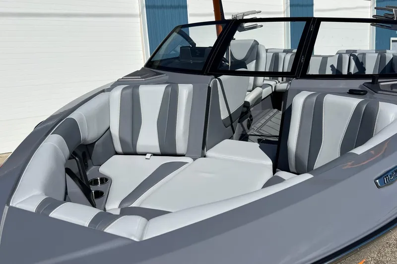 Slide: The Image of 2023 Malibu Wakesetter 22 LSV boat interior with gray and white seating. - 33