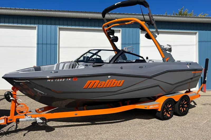 Slide: The Image of 2023 Malibu Wakesetter 22 LSV boat on trailer, gray and orange design. - 34