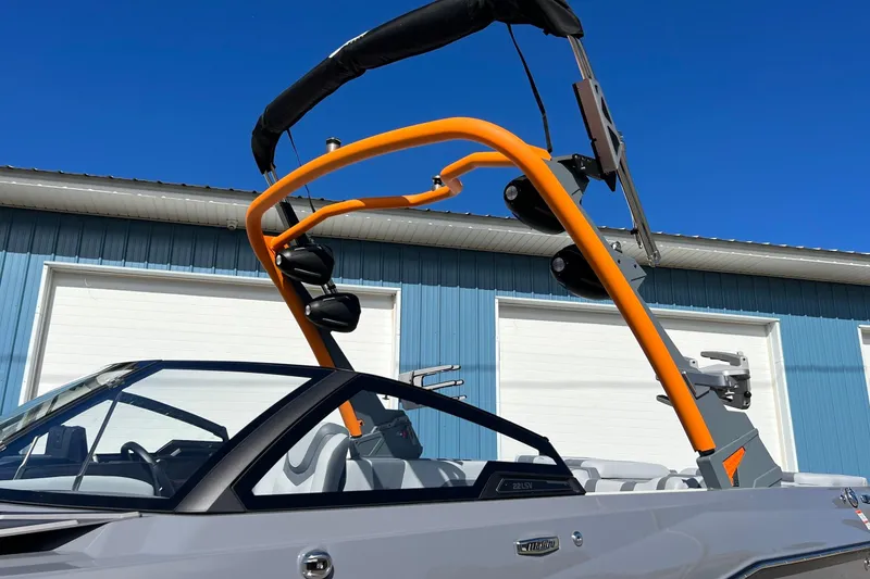 Slide: The Image of 2023 Malibu Wakesetter 22 LSV boat with orange wakeboard tower against blue sky. - 39
